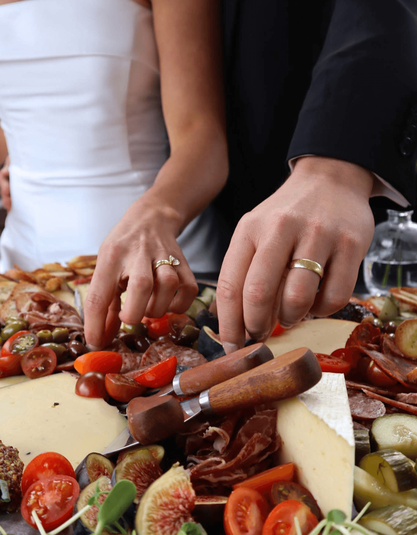 Couple celebrating engagement party at Ashlar Ottawa, eating curated charcuterie board