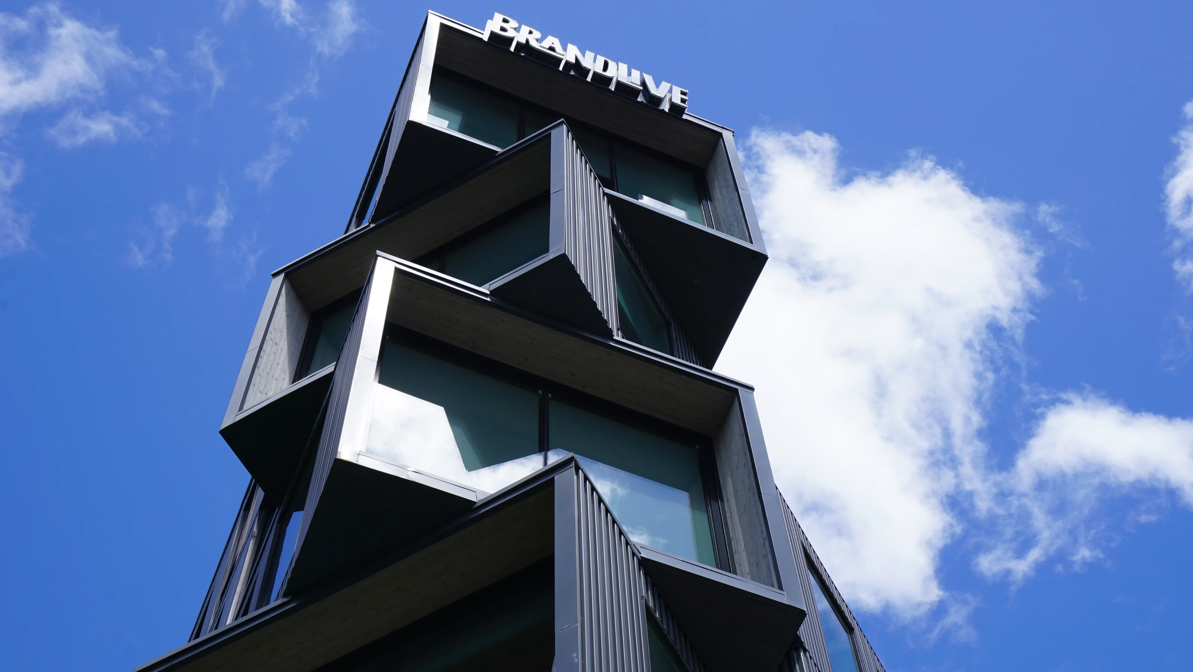Brandlive Portland HQ office building exterior with angular dark facade against a blue sky