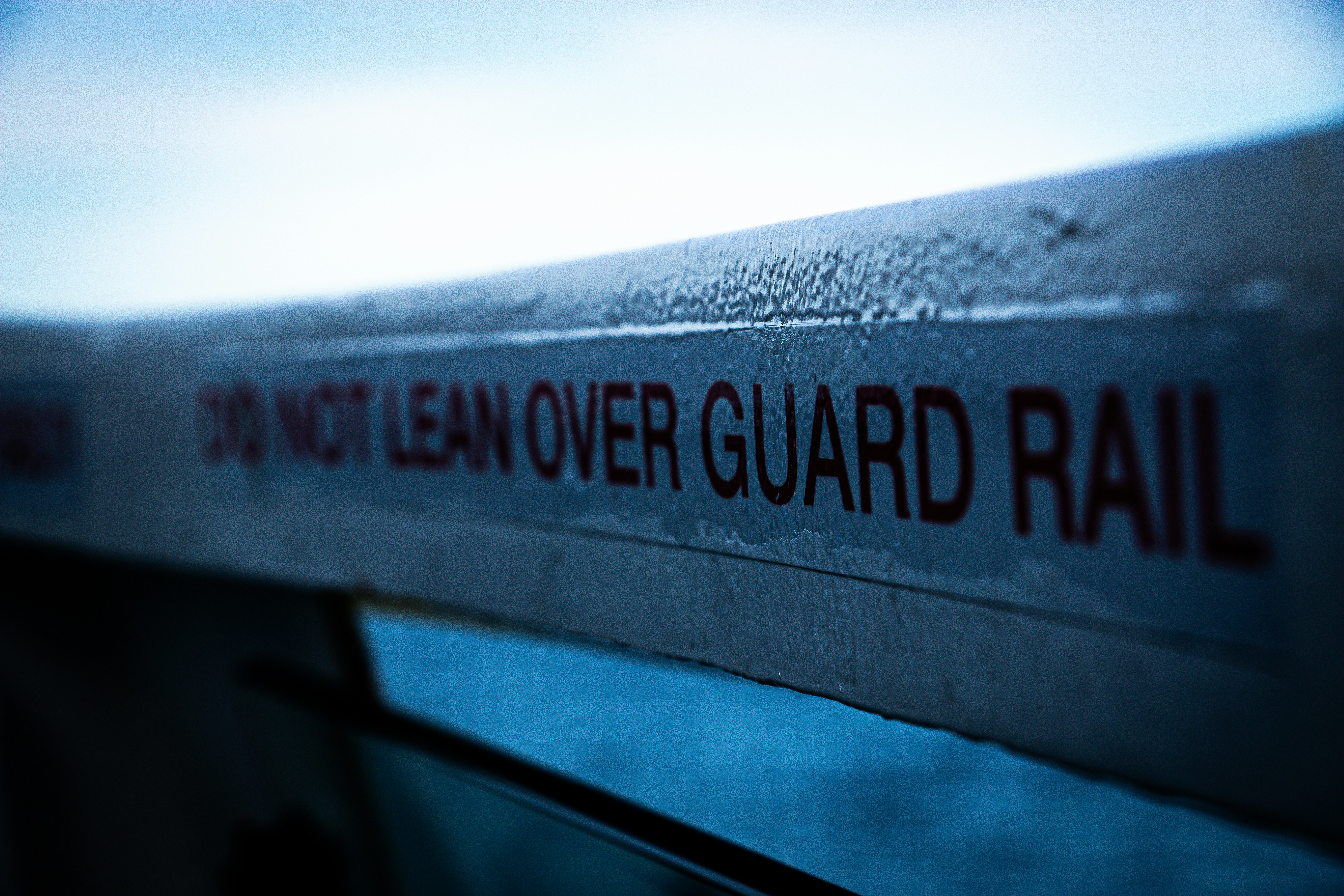 Do not lean over guard rail warning