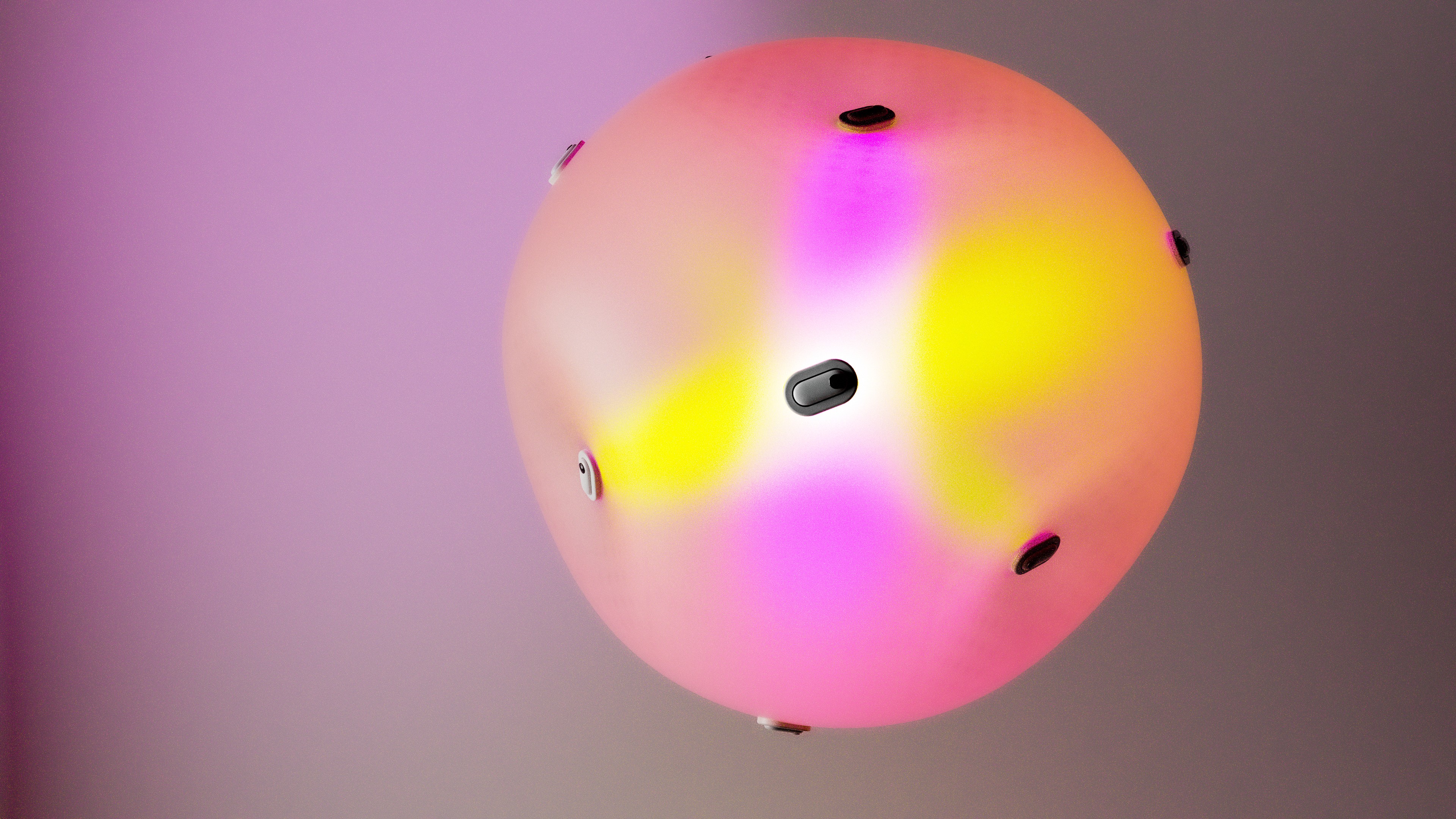 man wearing grey t-shirt standing in front of man sitting on chair