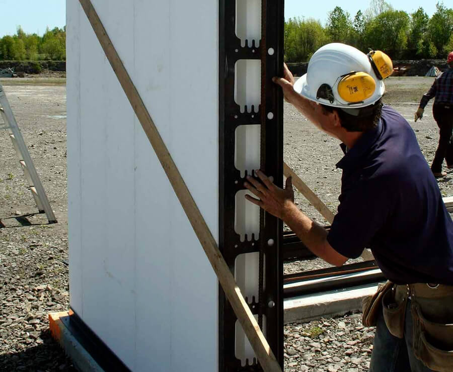 A man installing a vertical ICF panel