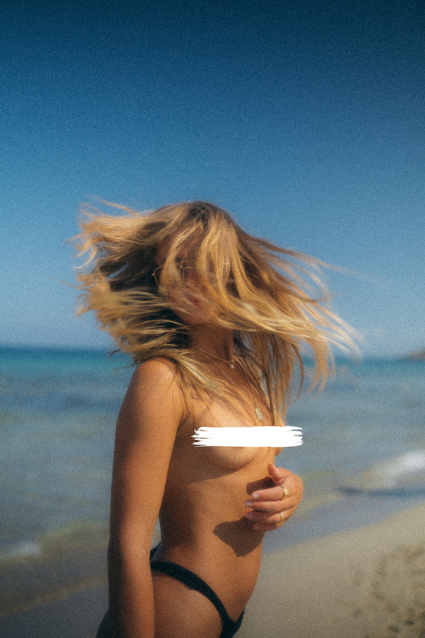 Interior view from living area toward the lake, large glass facade, minimal furniture.