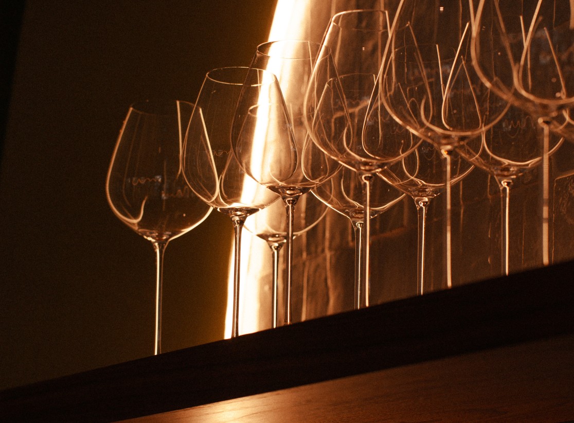 A woman sitting at a bar with a wine glass