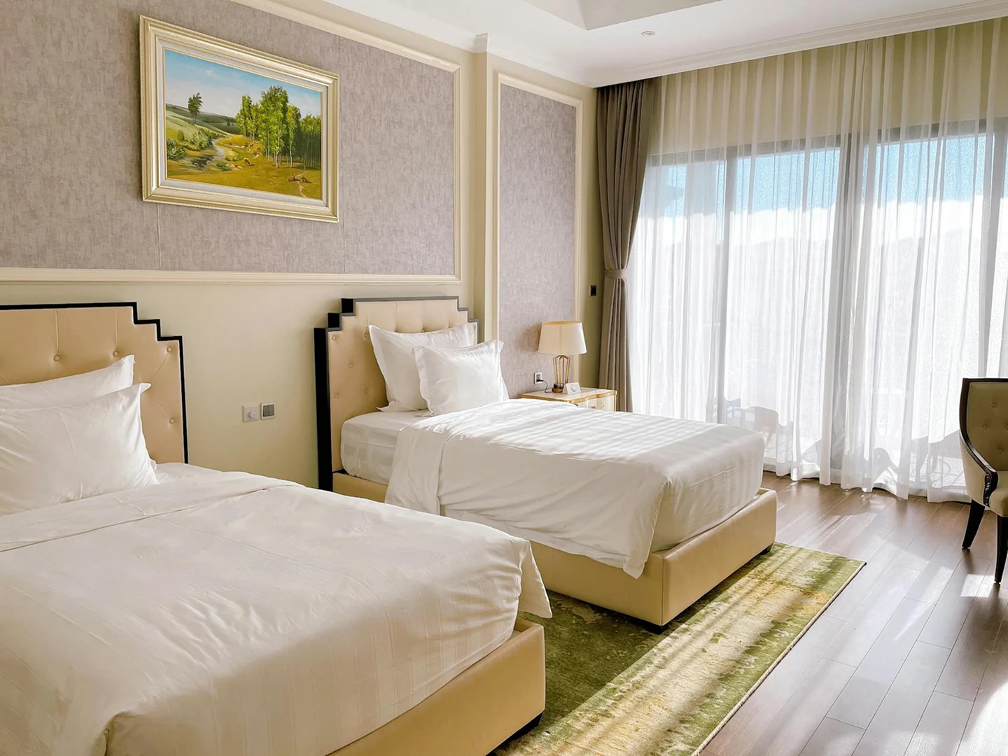 Deluxe pool view room with two beds, white linens, and soft natural light from large windows.