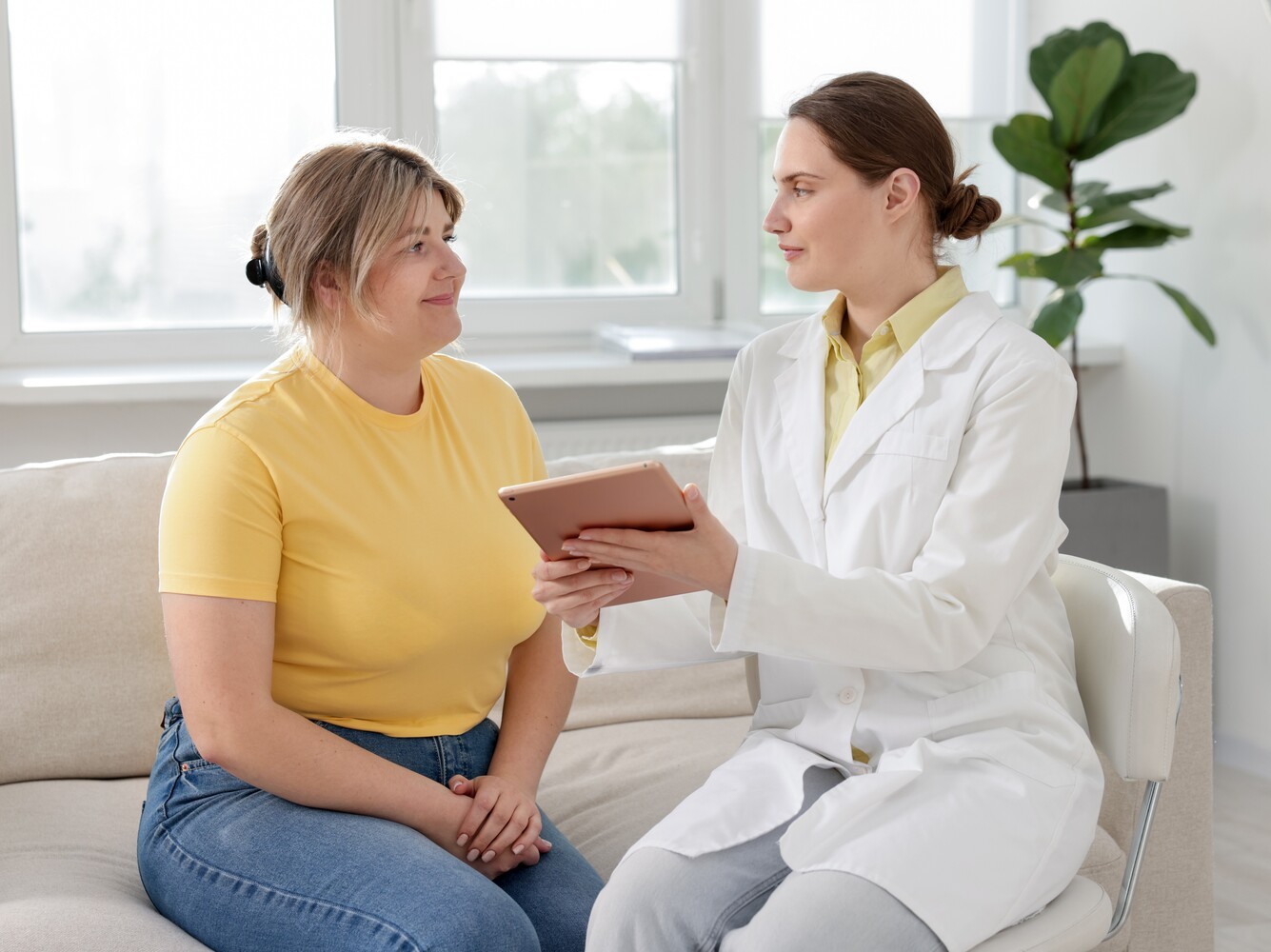 woman sitting in a doctor’s office asking her physician if using a treadmill to lose weight is right for her