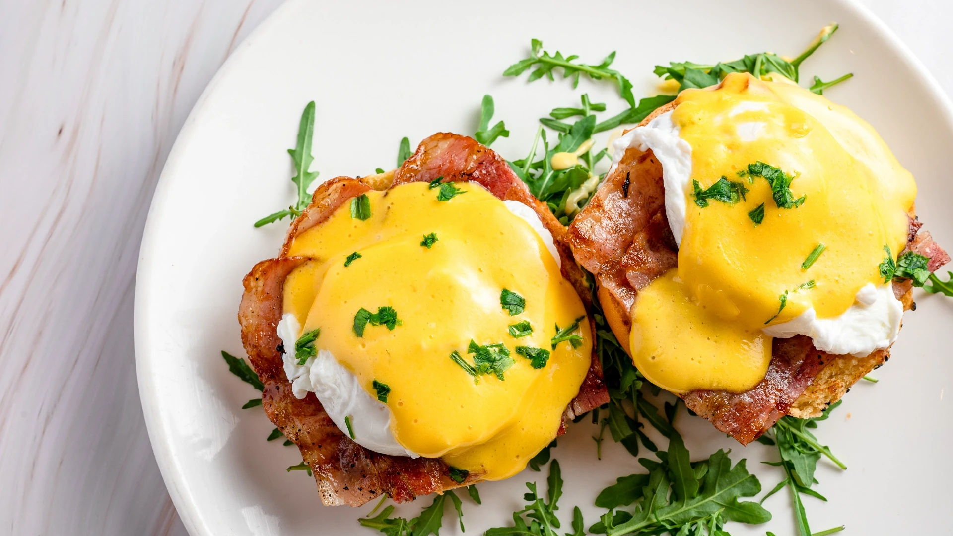 a glass of cocktail with a slime orange fruit