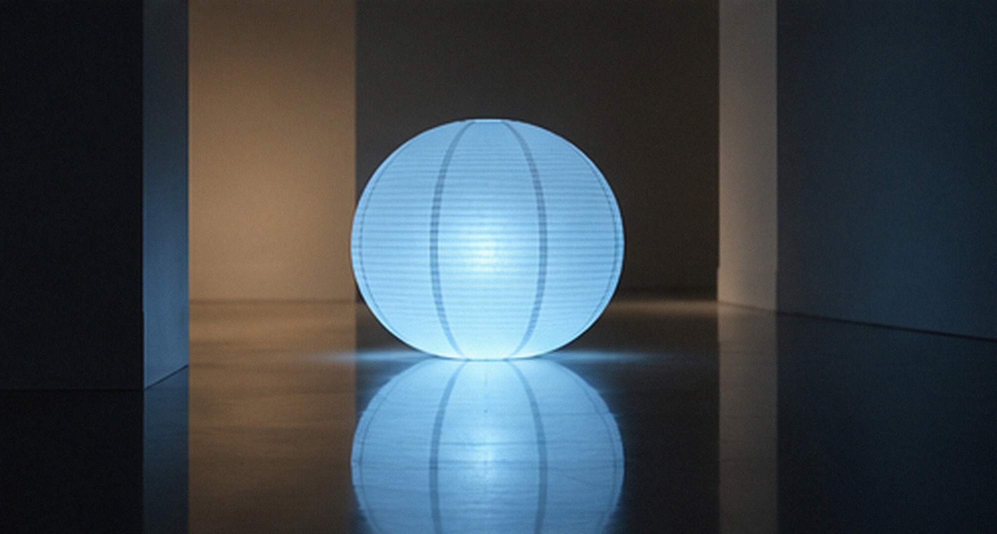 A single illuminated sphere in a dark space