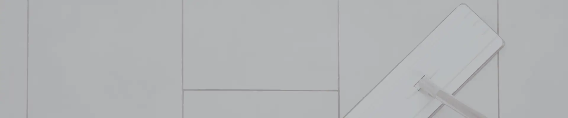 Dorm cleaning essentials like mop on tile floor – often overlooked items to add to your college packing list.