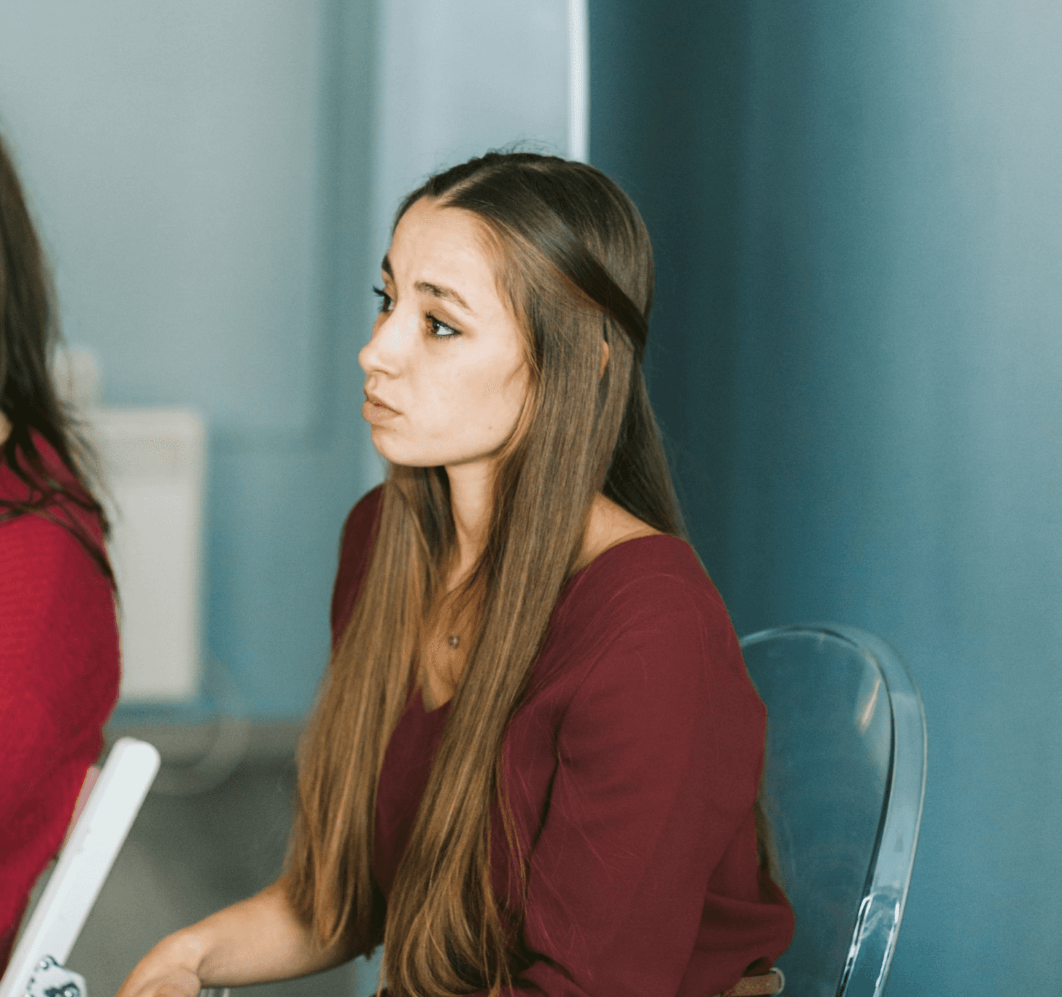 woman sitting around table holding tablet