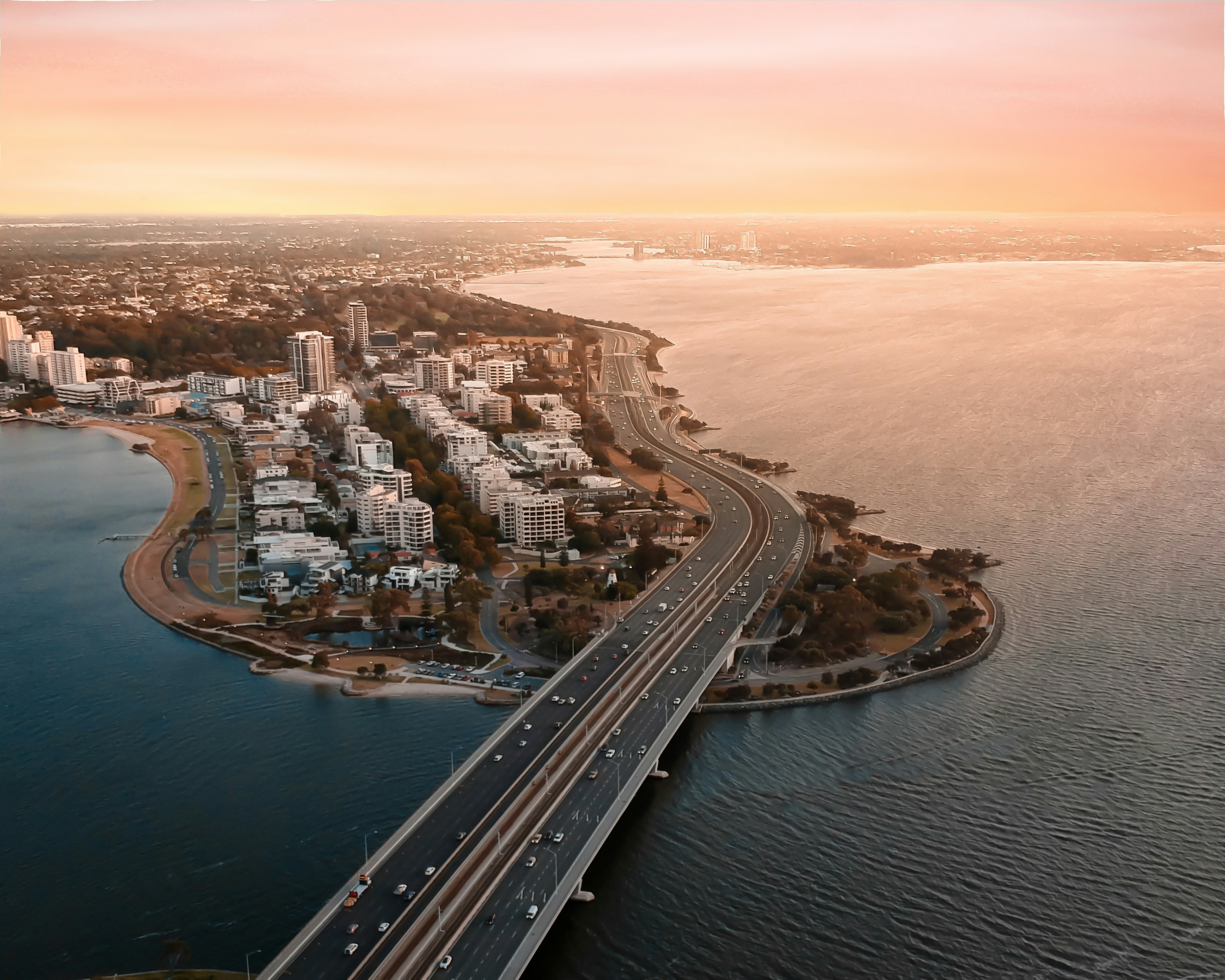 aerial view of city buildings near body of water during daytime