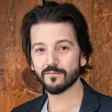 Diego Luna headshot against a brown background