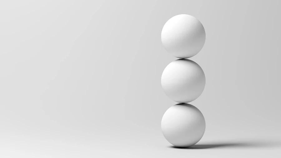 Three white spheres stacked vertically on a light gray background.