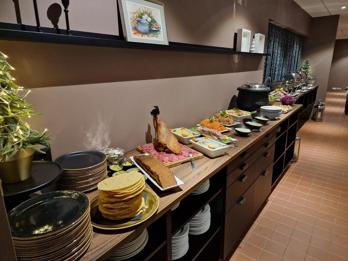 "Dinner service at Hotel Bifröst restaurant with warm lighting