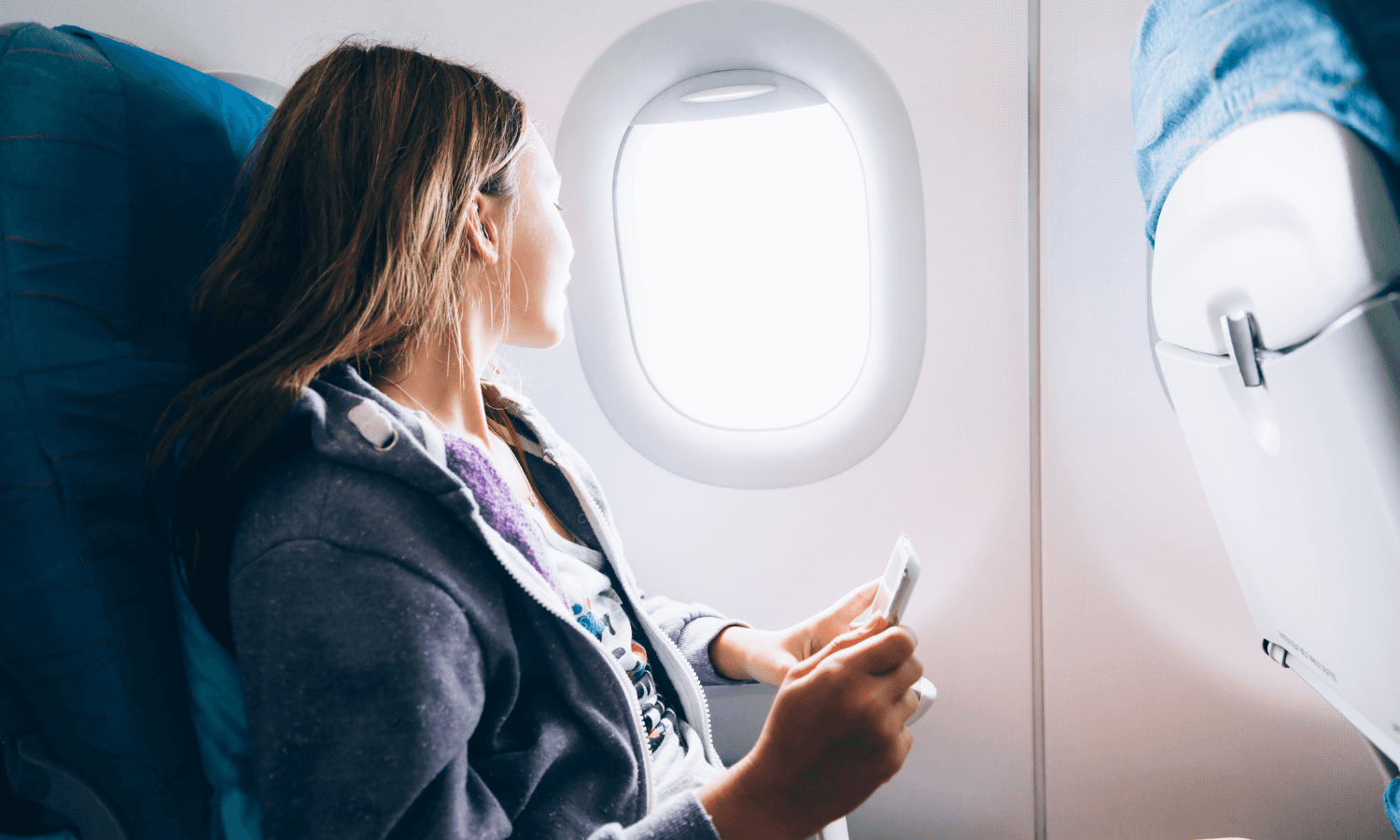 Woman looking out plane window