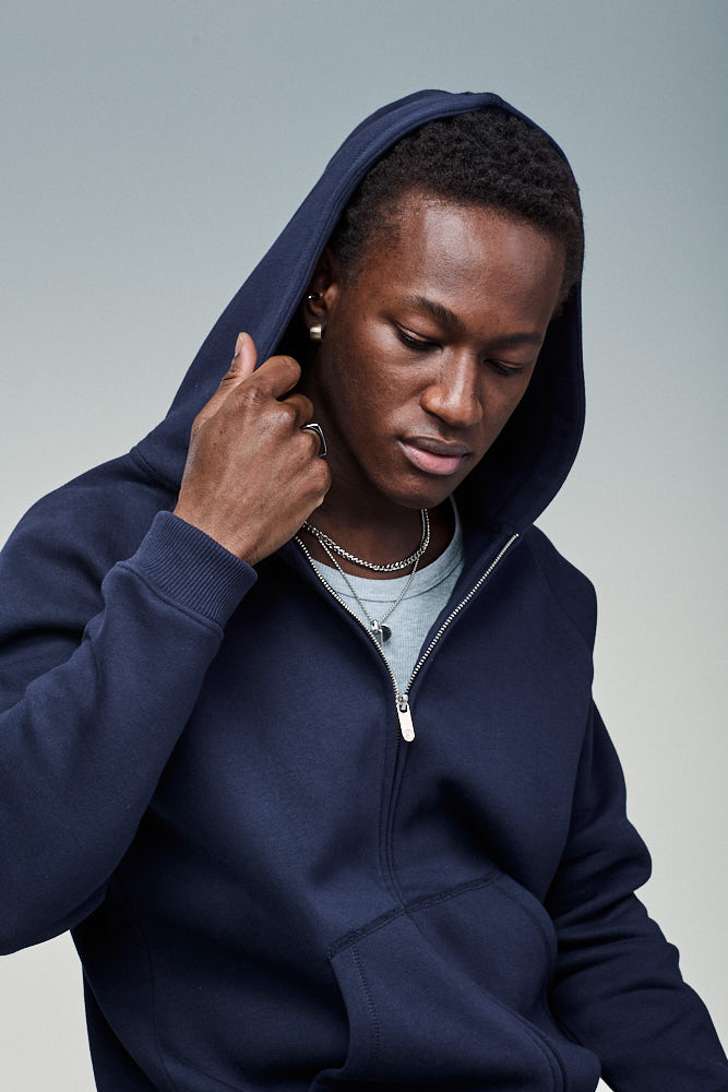 Model in Sunday Superior navy organic cotton zip hoodie