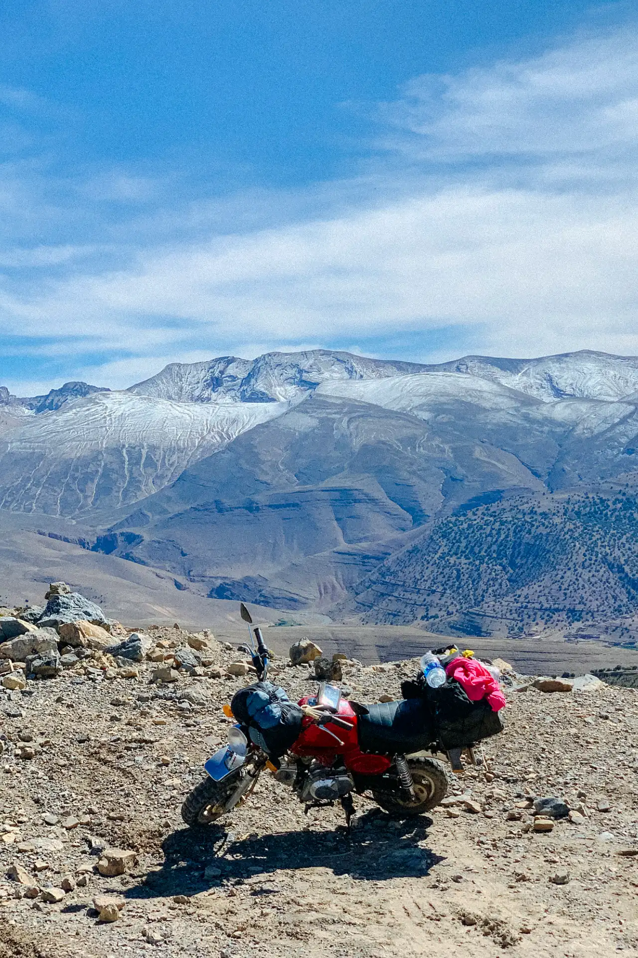 A motorcycle parked on a mountain overlook.