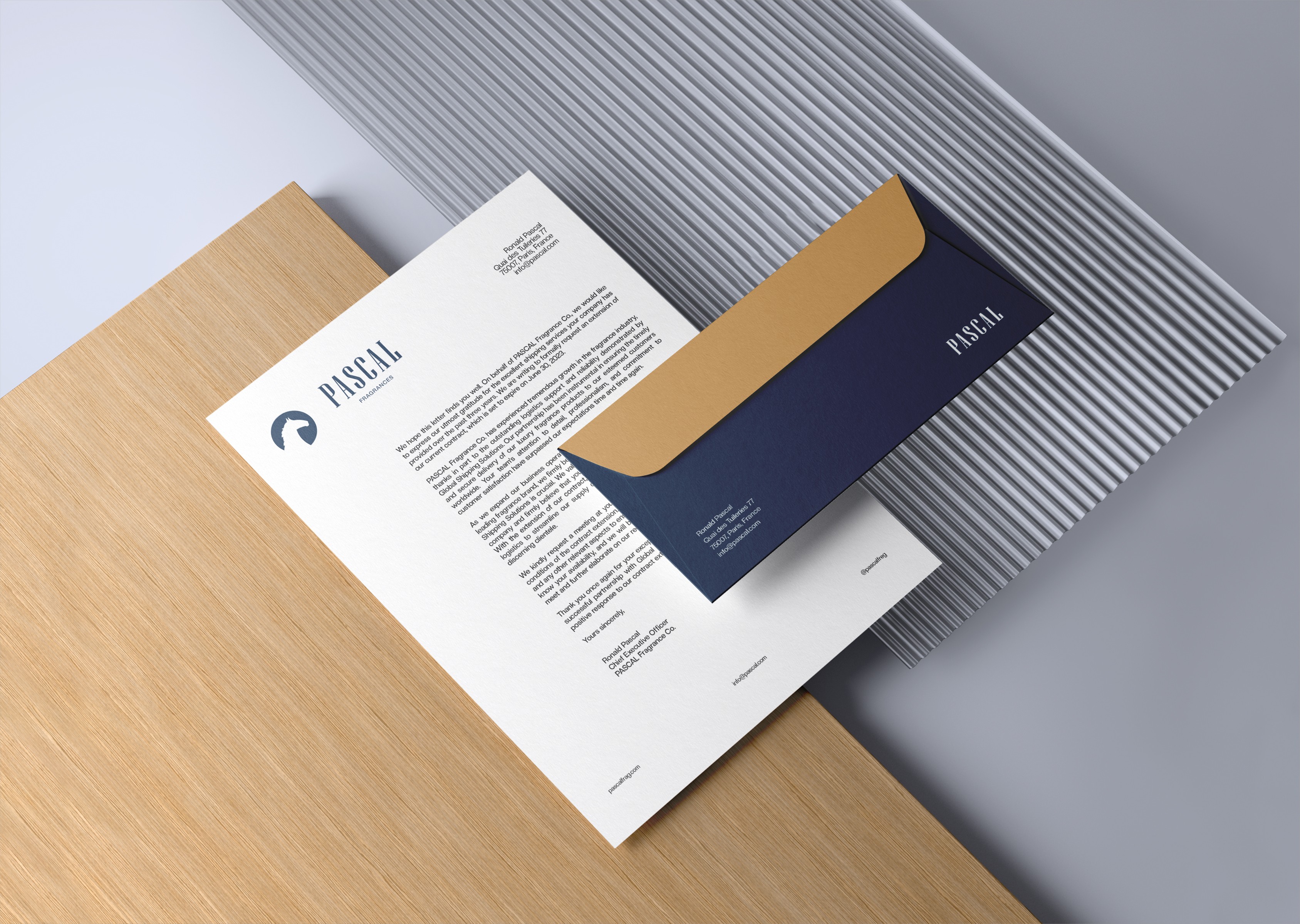 Cosmetic Company Letterhead And Envelope In Use, Floating Letterhead And Envelope, Letterhead And Envelope Floating Above Wood And Glass Panel