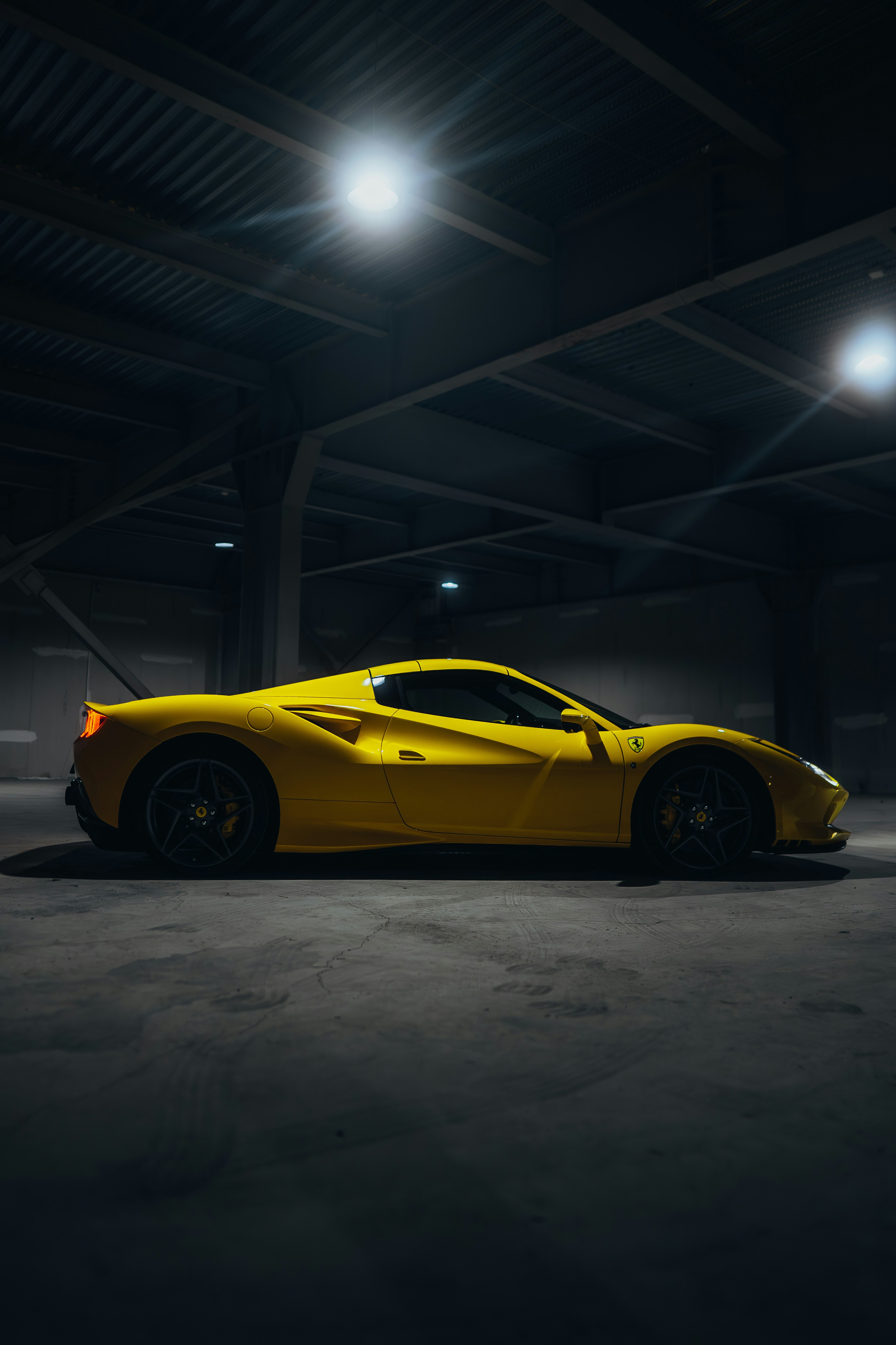 a yellow sports car parked in a parking garage