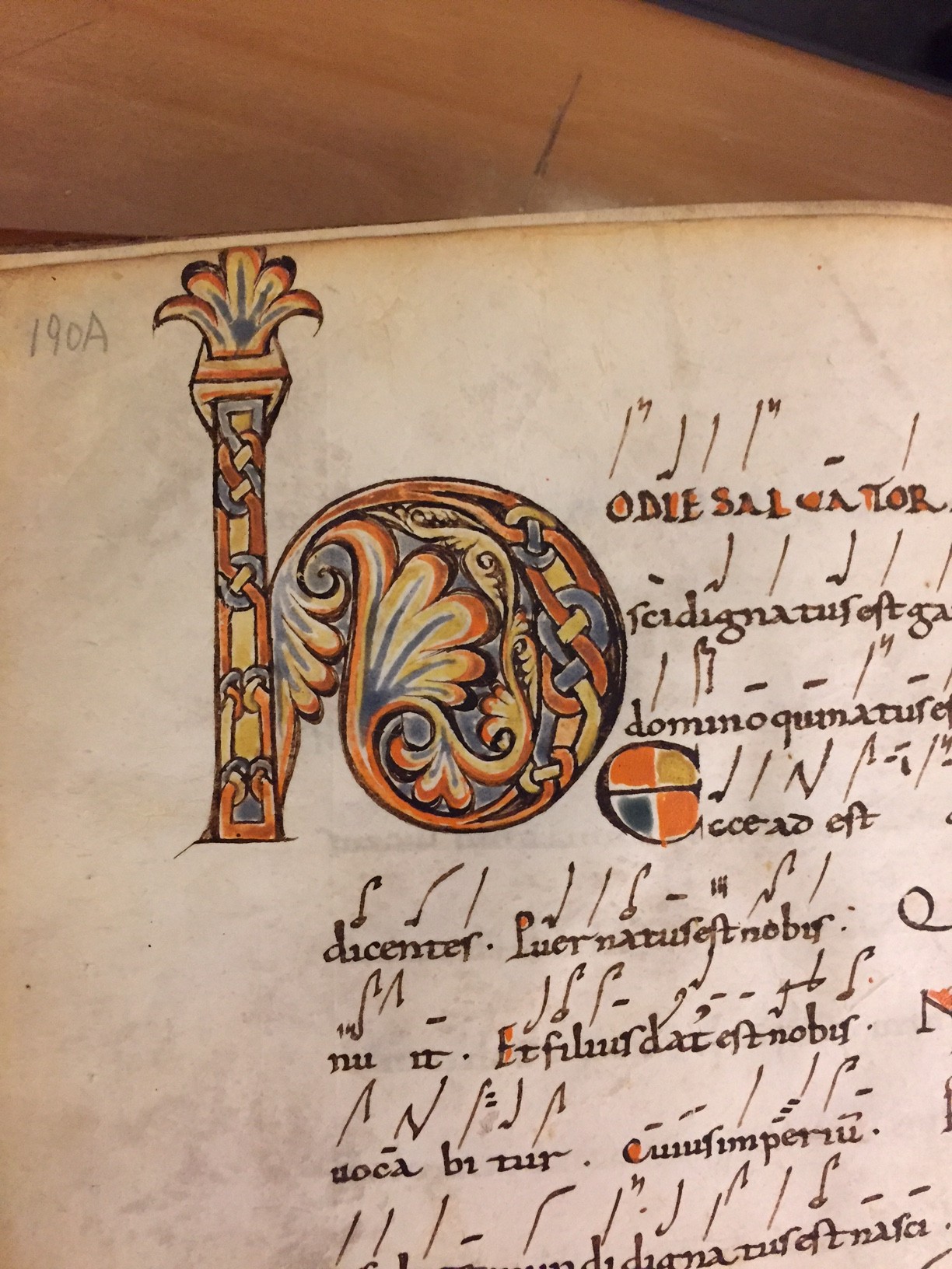 Calligraphic writing and drawing from an old book. A stylized pillar is also drawn on the page near the text.