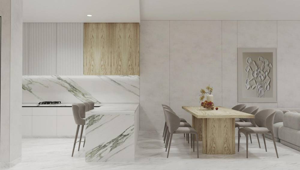 Modern kitchen and dining area featuring white and marble finishes at Radiant Marina Towers.