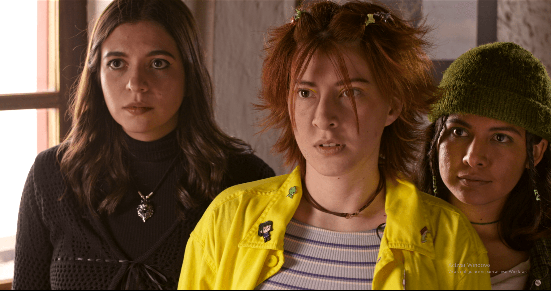 Woman in a light suit sitting thoughtfully against a terracotta wall