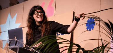 A speaker delivering a presentation at the conference.