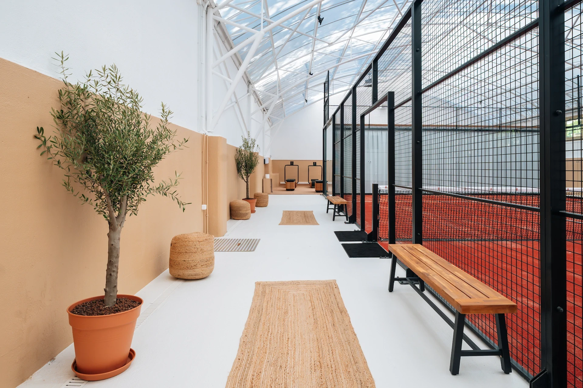 Terrain de padel couvert, intérieur moderne avec verrière, sport et loisirs.