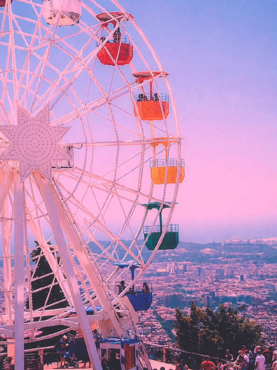 A Ferris wheel with red, orange, and yellow gondolas against a hazy pink and lavender sky over a faded-violet cityscape — the purple, cerulean, and violet palette at the heart of Retrica's MAGIC series