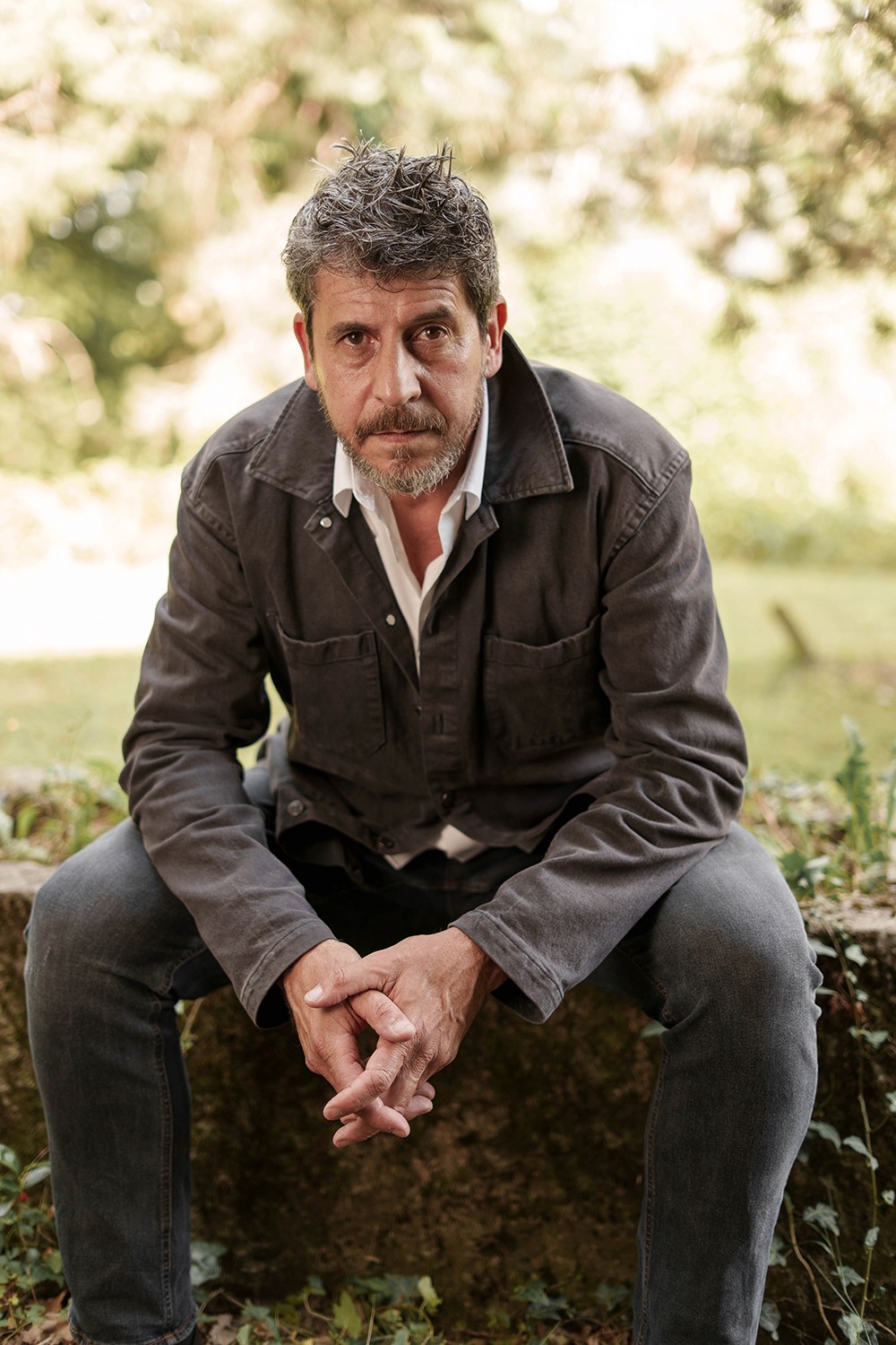 Portrait homme extérieur assis penché coude sur les cuisses