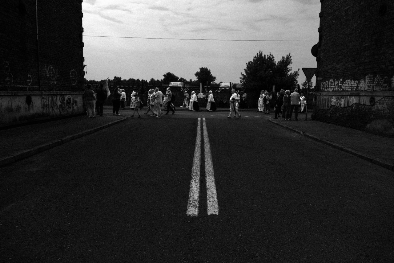 Crowd of people participating in a religious celebration in Poland, black and white reportage.