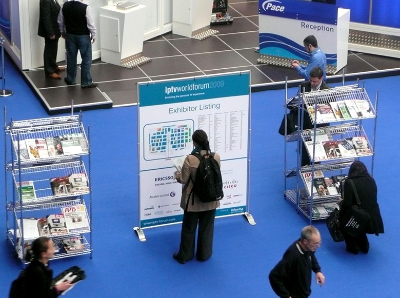 Person standing in front of floor plan signage at an IPTV forum.