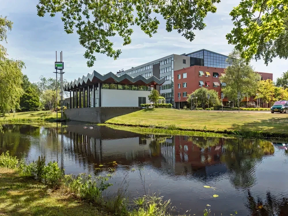 A person stands silhouetted in a vast, illuminated cave.