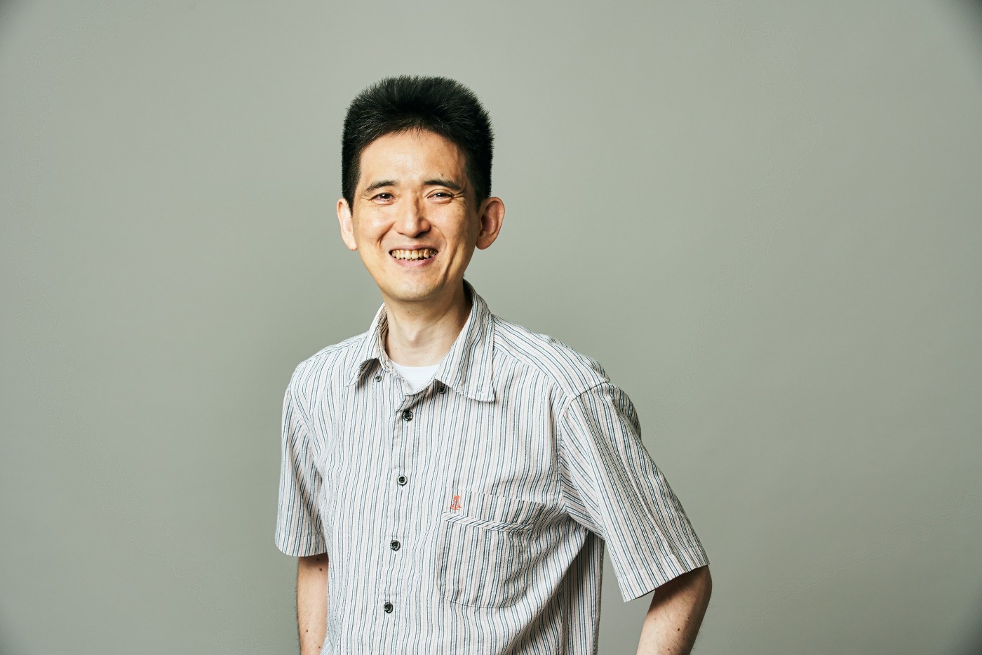 A minimalist illustration of a woman's face with her eyes closed, showcasing soft, blush-toned cheeks and dark hair styled in an updo.