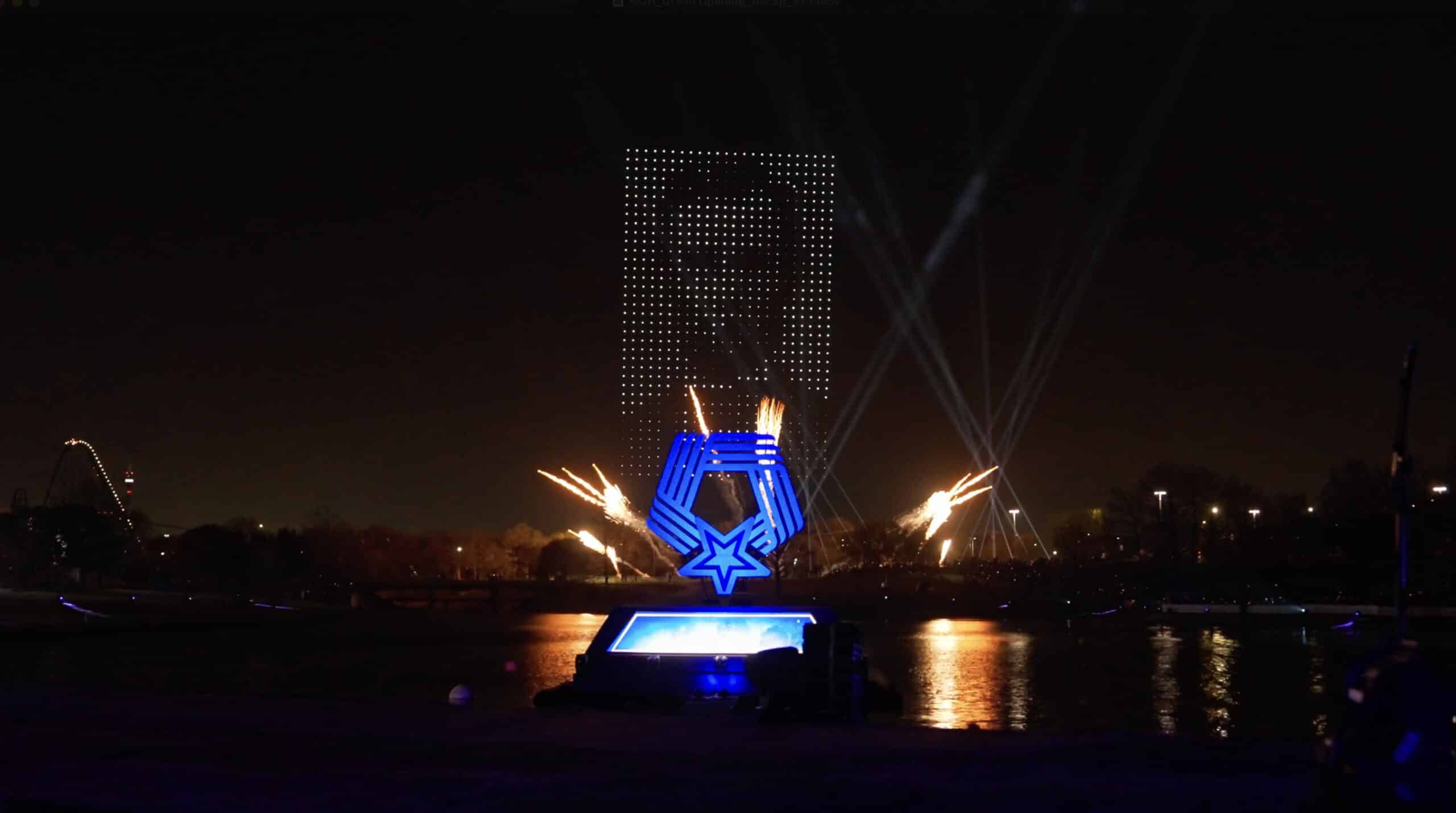 Fireworks igniting behind the National Medal of Honor logo on the water