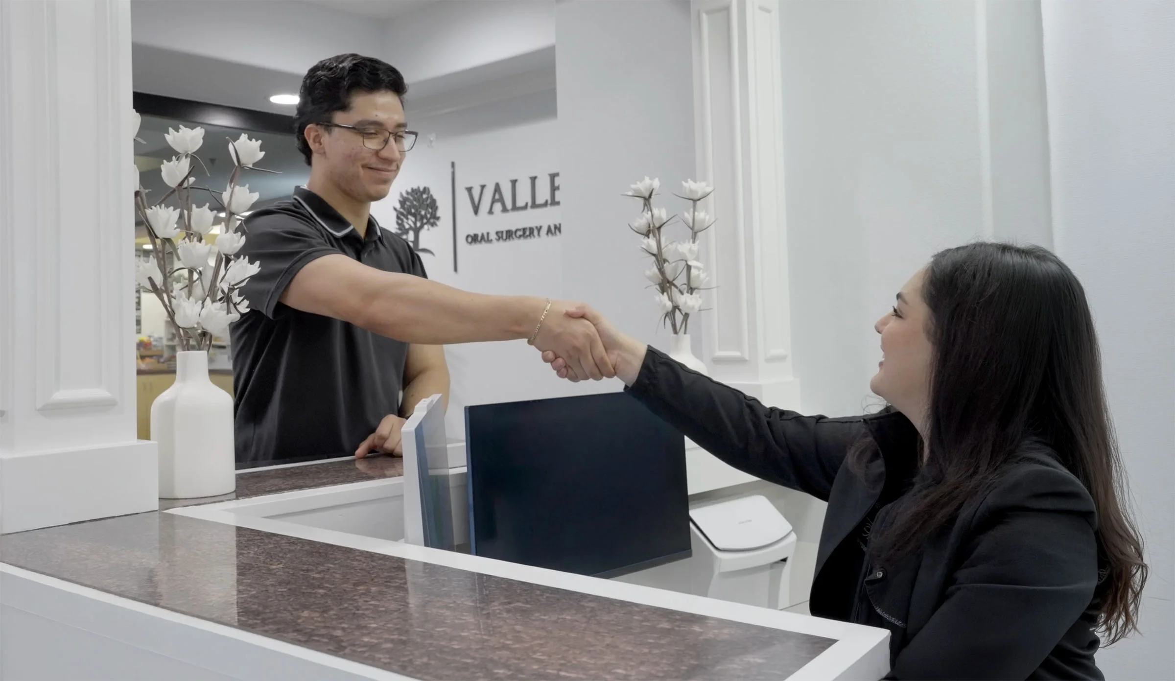 Valley Oak Oral Surgery front desk staff welcoming a patient at the Fresno, CA office