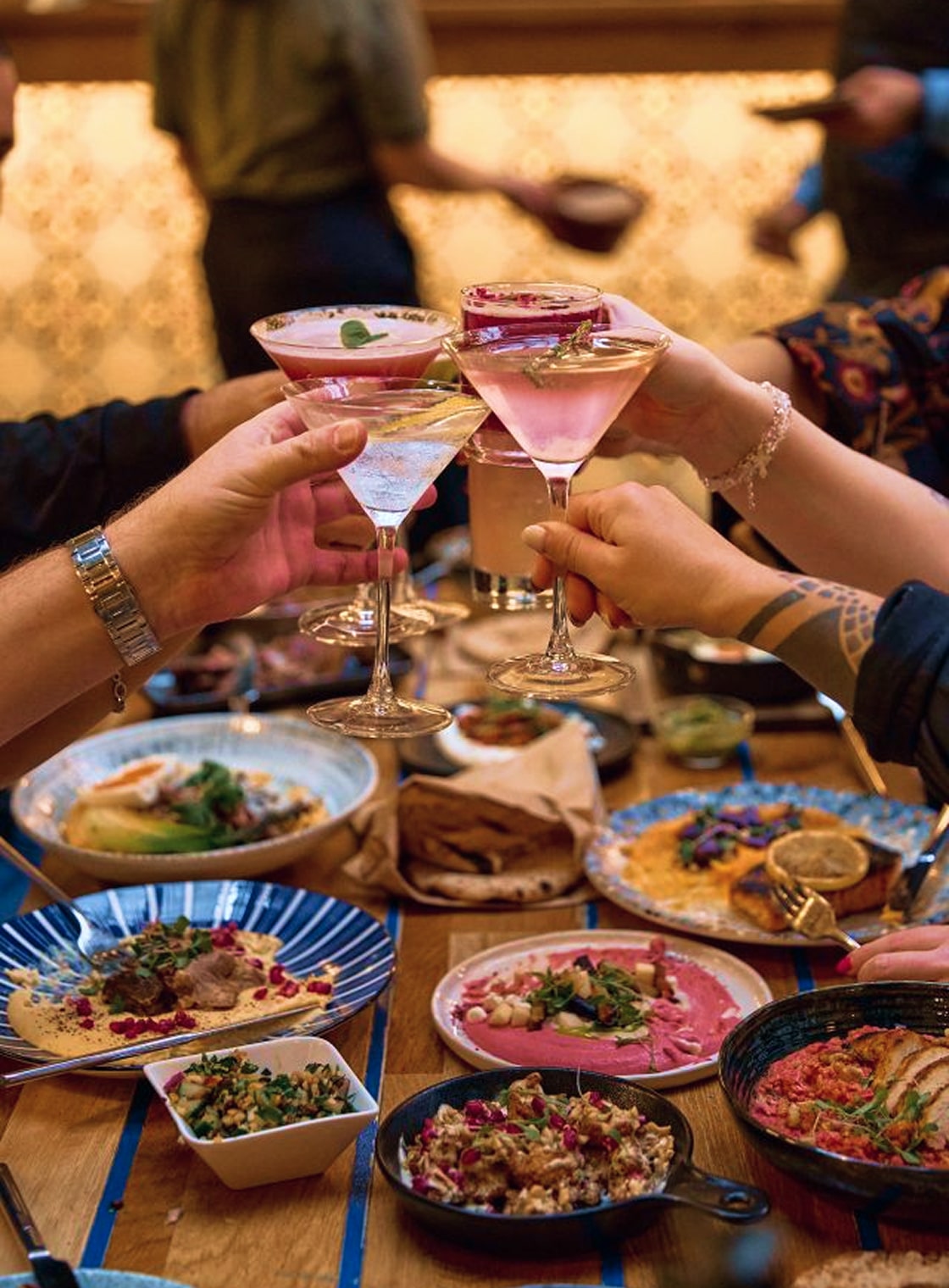 People sharing food at Mazeltov restaurant
