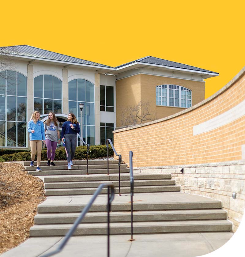 Three students decend the steps on UIU's Fayette campus