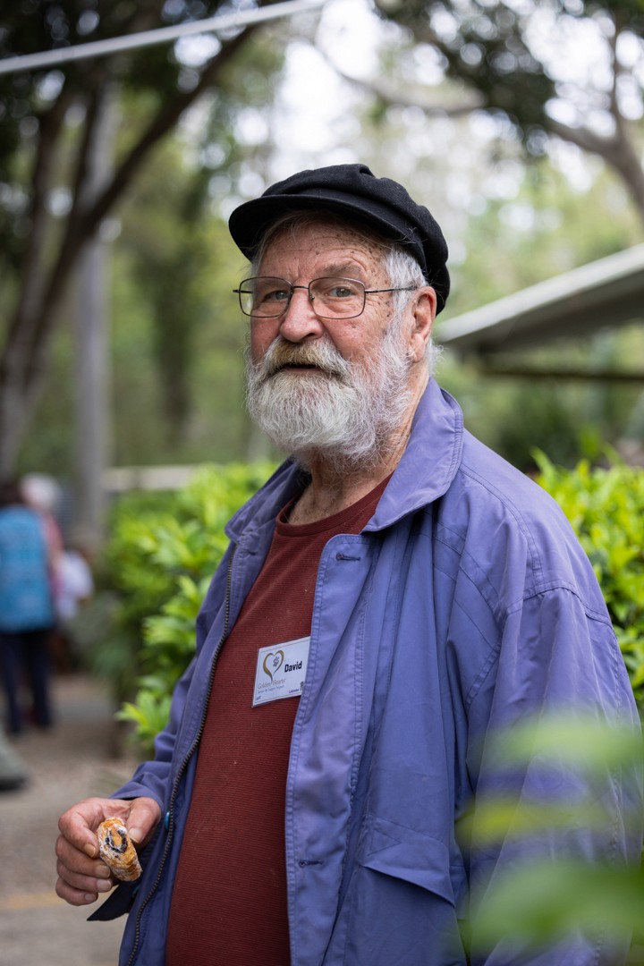 Man with beard holding pastry