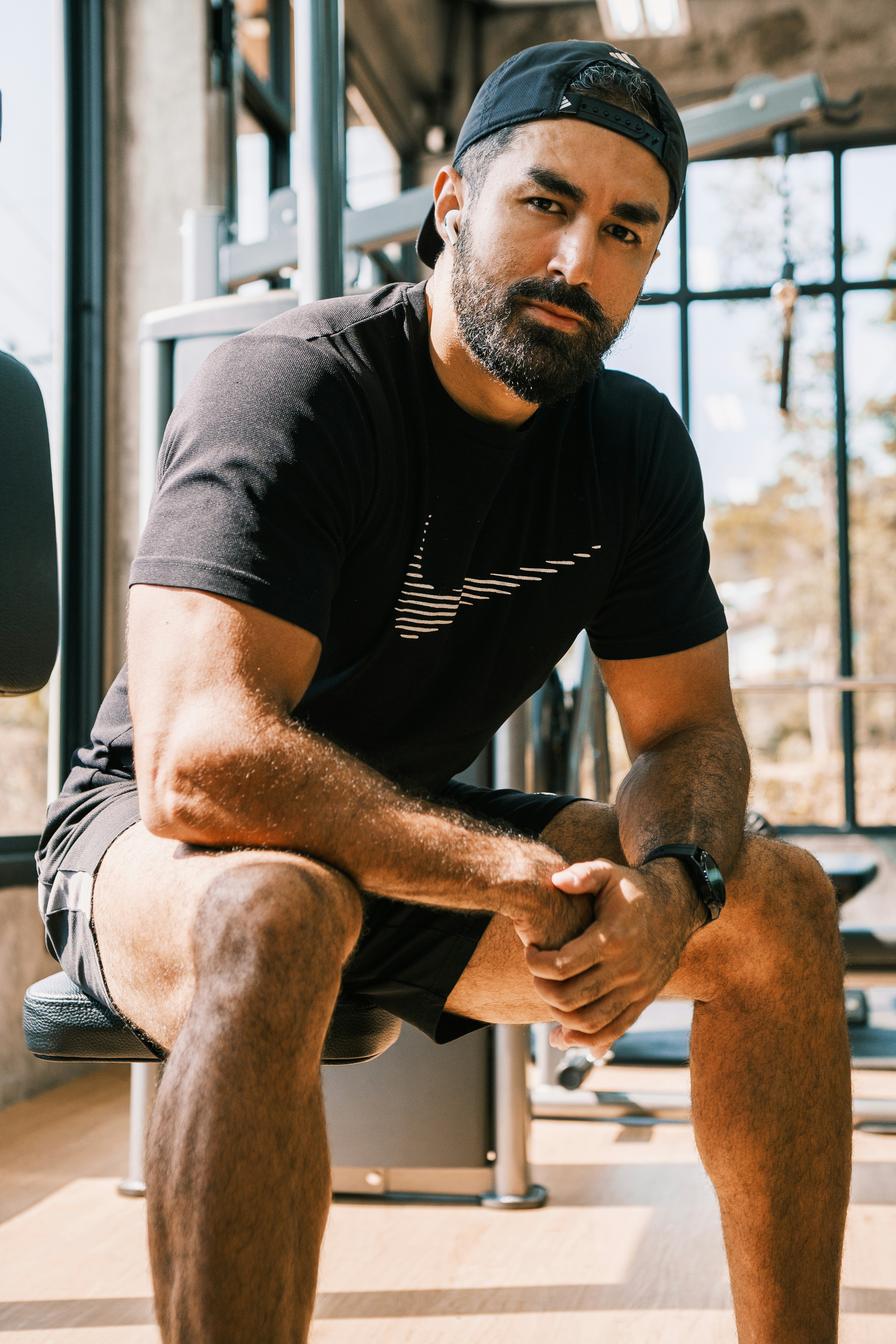 a man sitting on a bench in a gym