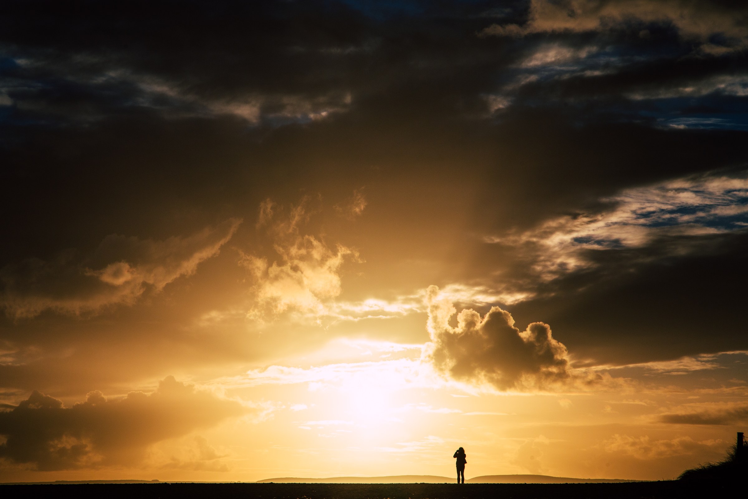 TRAVEL · A lone figure against the evening sky.