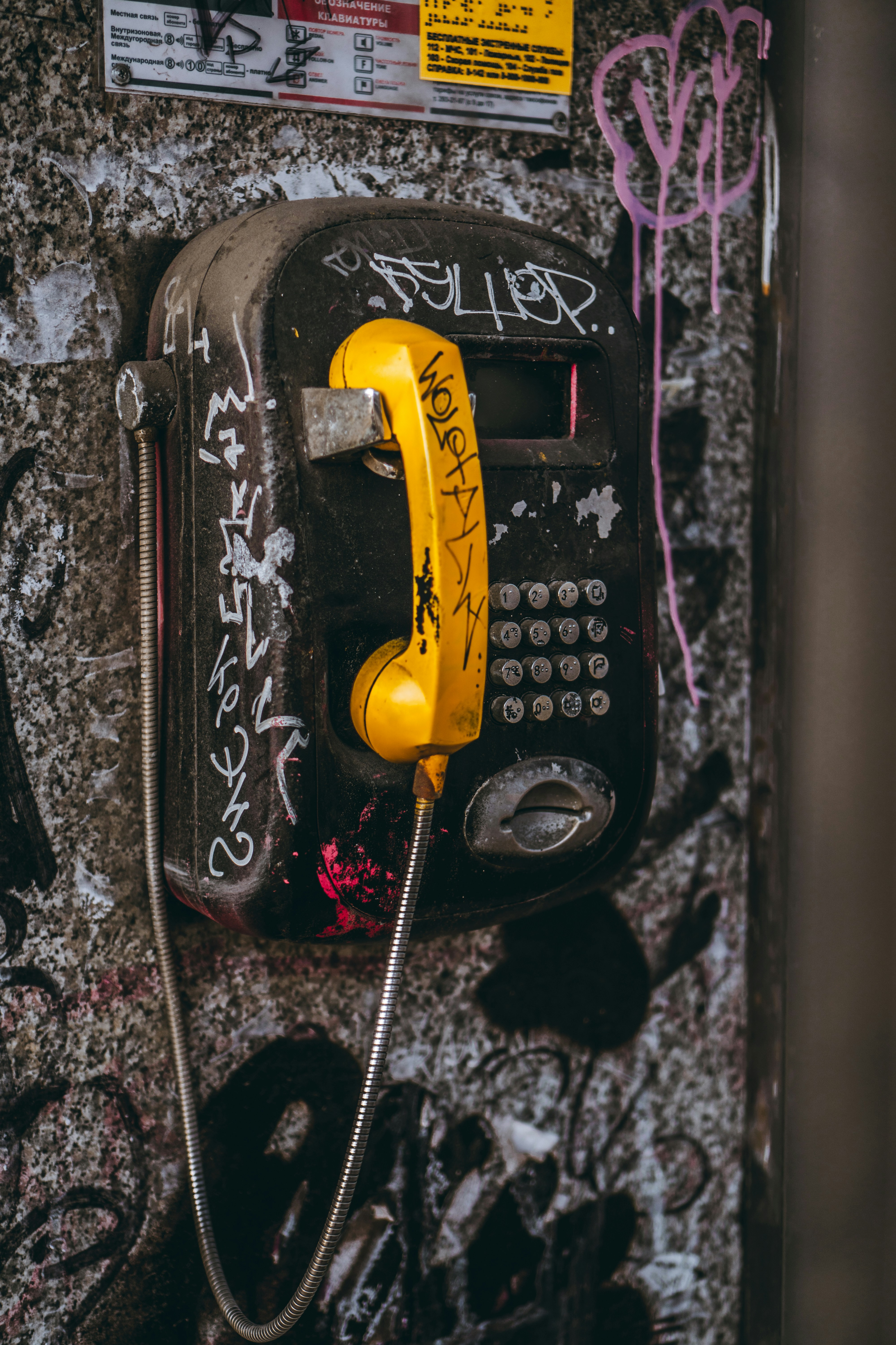 black and yellow telephone on black and white textile