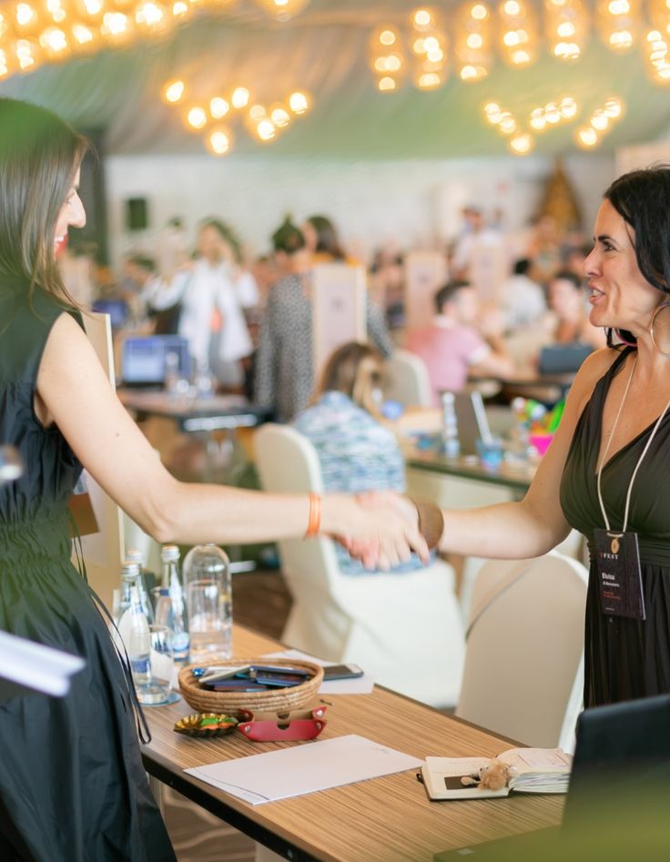 A woman in a straw hat stands in the grass