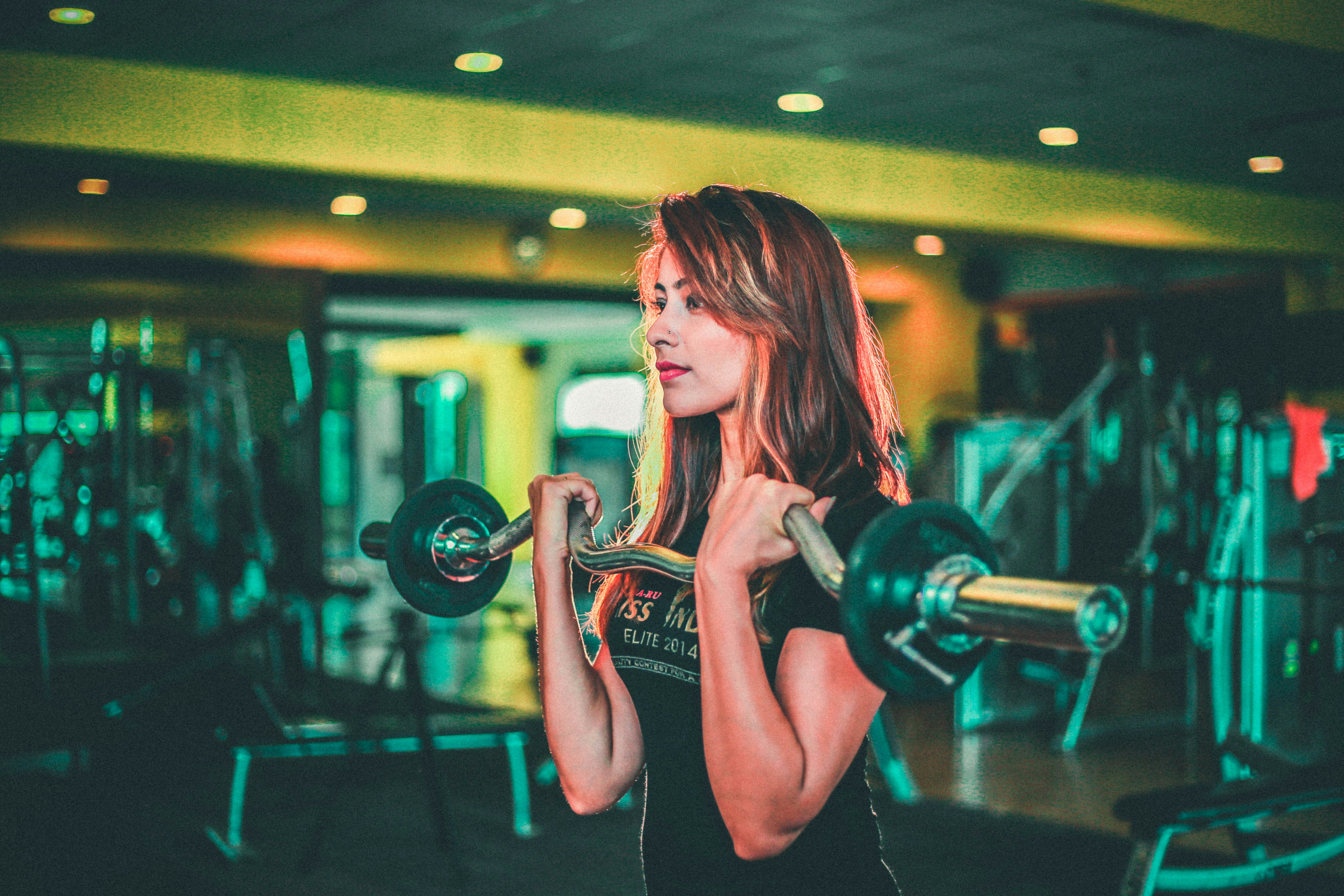 Lady Doing Bicep Curls at the Gym