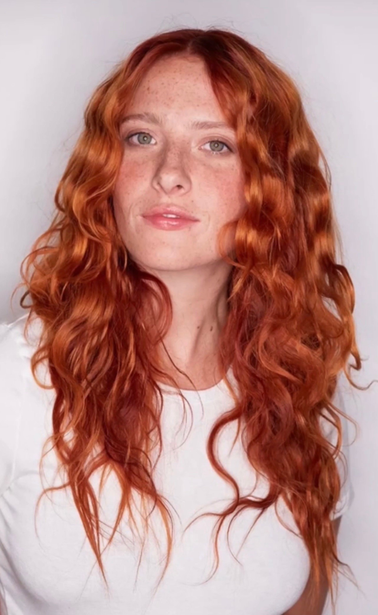 Vibrant copper hair at Bomane Salon – bold, orange-red tones for a striking look.