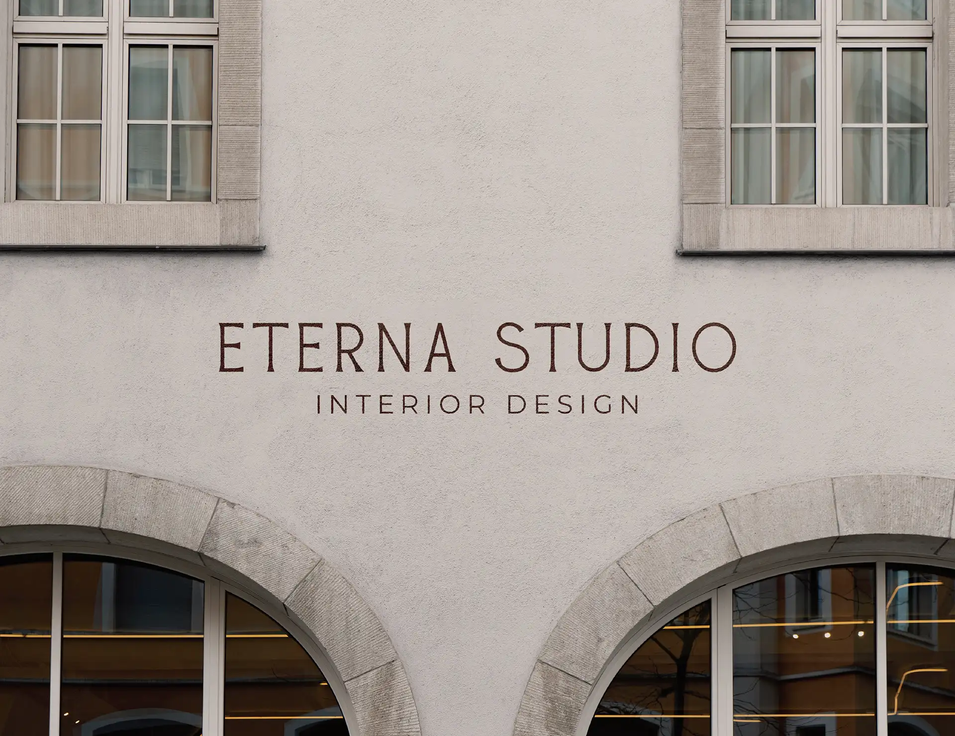 Eterna Studio interior design brand identity applied to building signage showing logotype in architectural context
