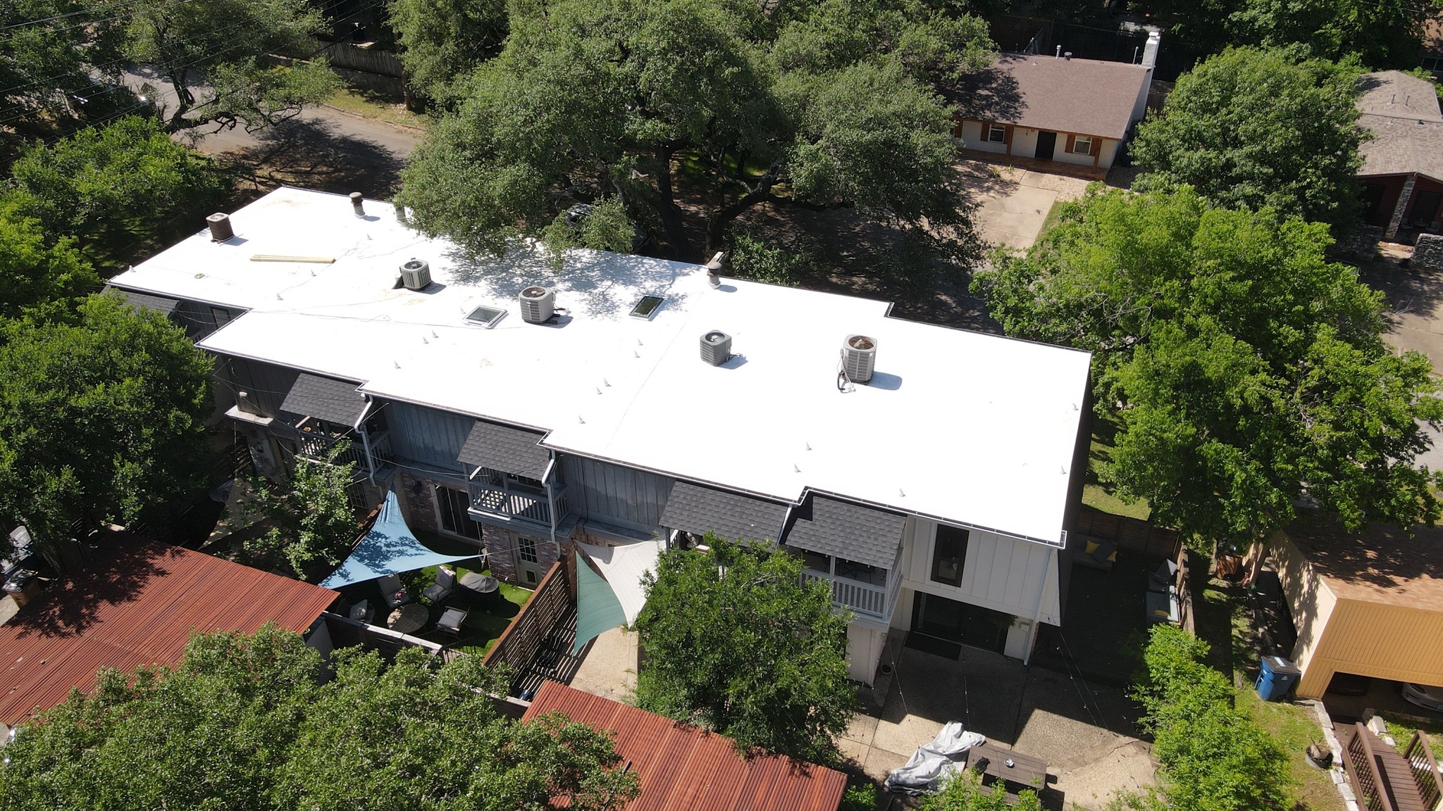 5 unit condo flat fully tapered TPO system, color white.  With new gutters and mansard shingle roof.