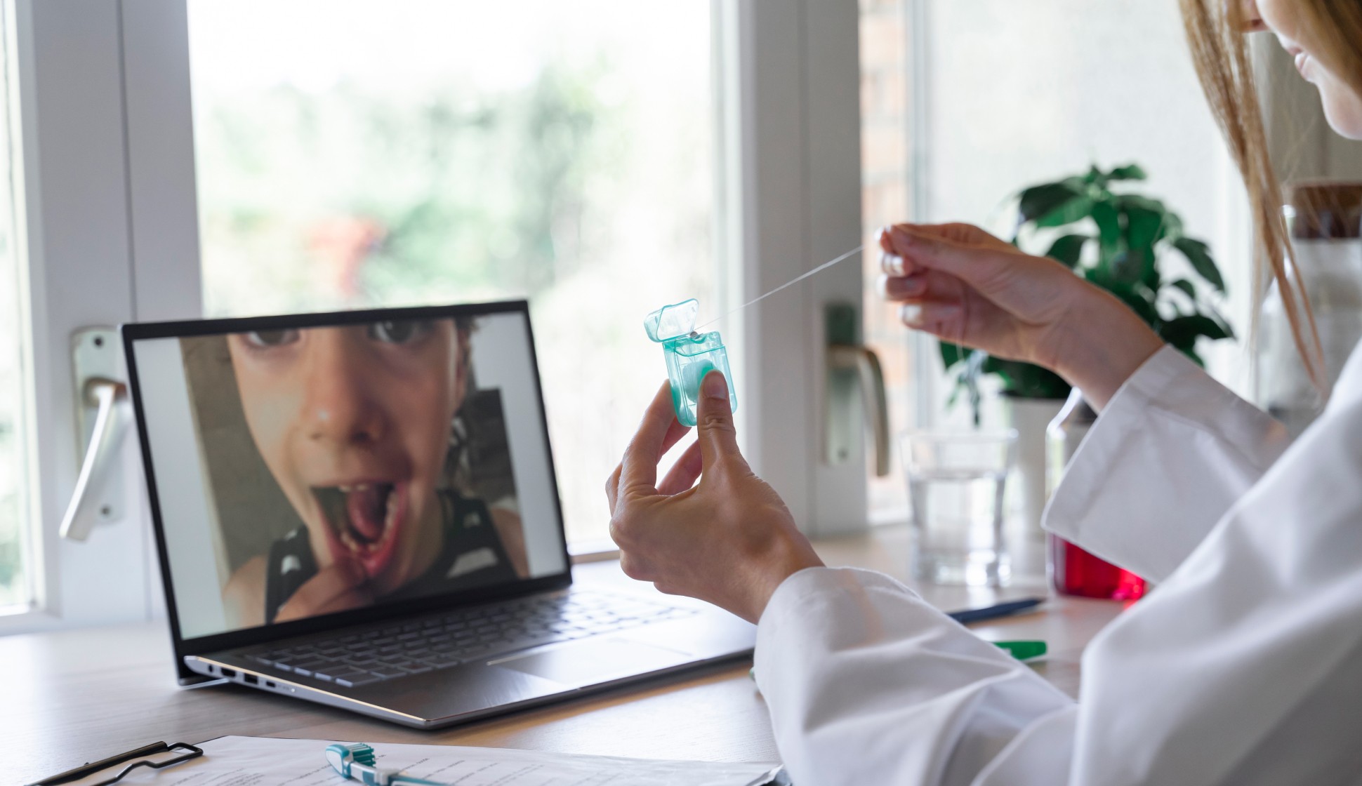 photograph of a doctor during a telehealth session with a child