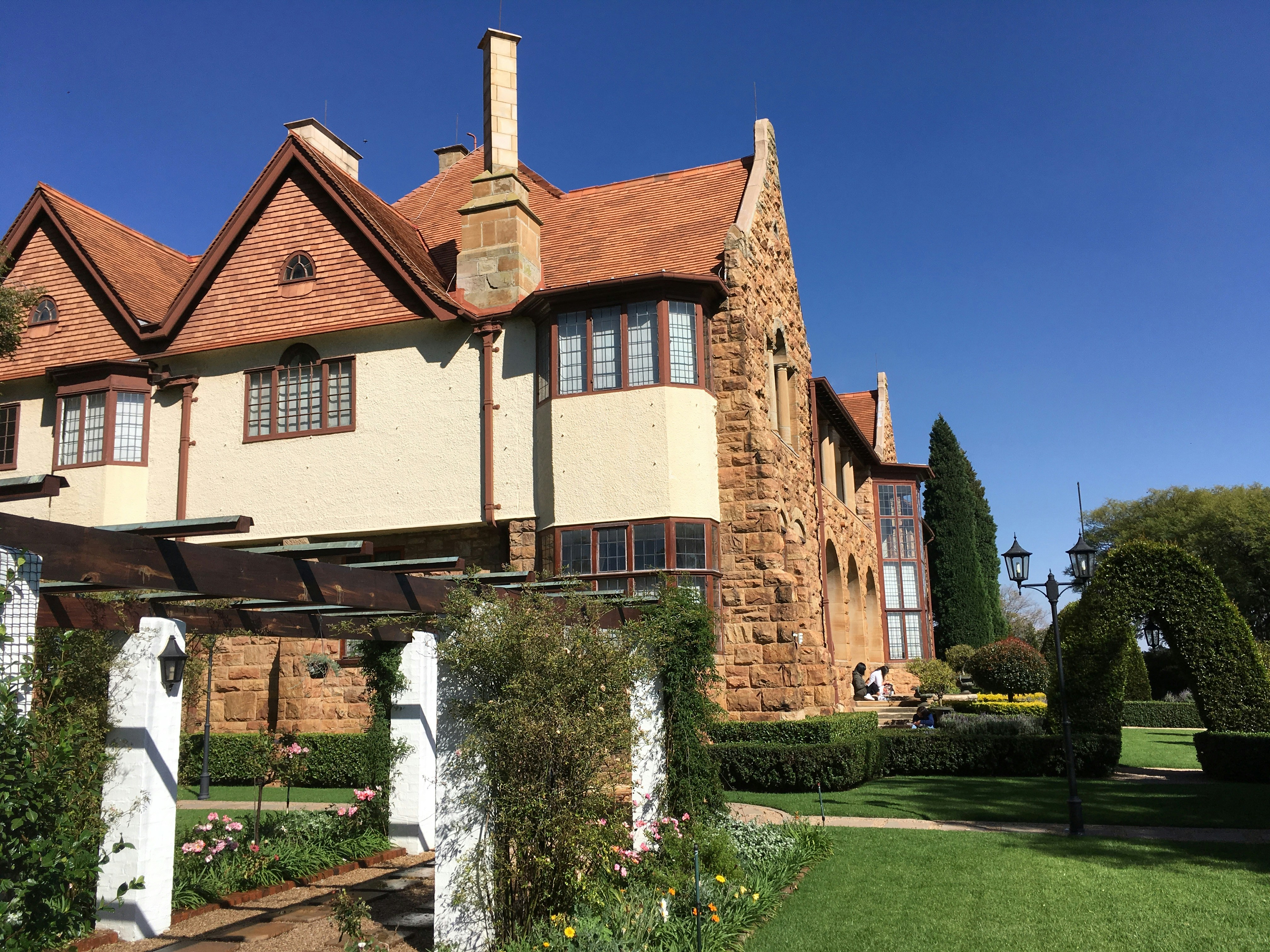 a large house with a garden in front of it