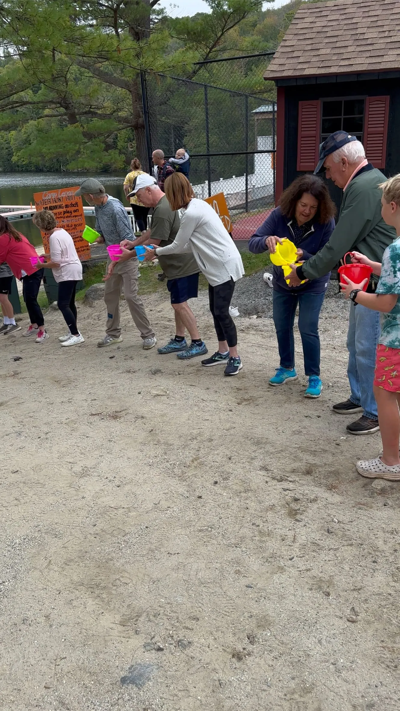 Retreat group playing a water bucket relay game at Camp Lenox