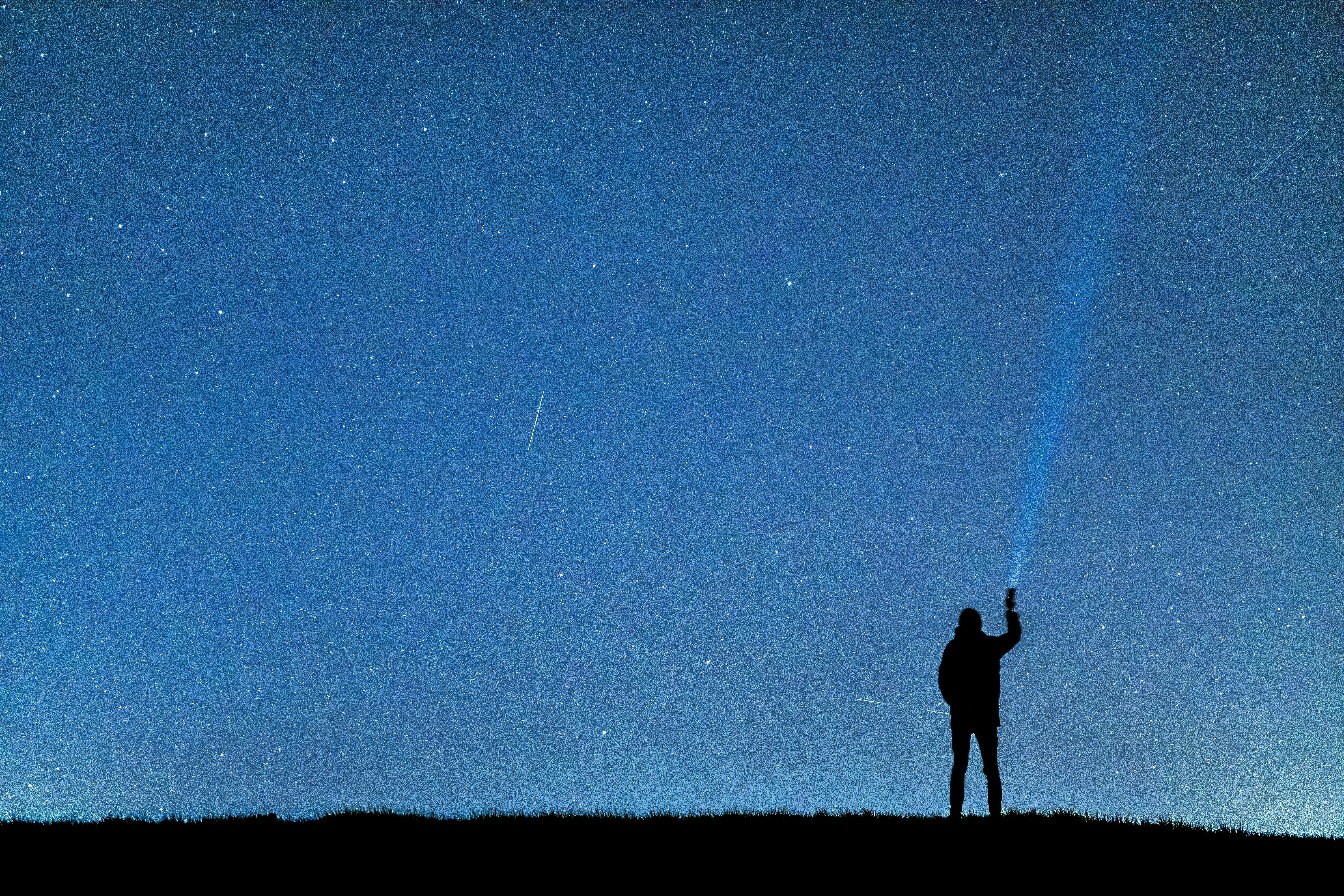 A person stargazing in a wide open sky